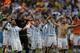 Argentina's Lionel Messi and teammates celebrate at the end of the World Cup quarterfinal soccer match between Argentina and Belgium at the Estadio Nacional in Brasilia, Brazil, Saturday, July 5, 2014. Argentina won 1-0. (AP Photo/Eraldo Peres)