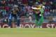 South African one day international team captain AB de Villiers plays a shot as Sri Lankan wicket keeper Kumar Sangakkara watches during the first one-day international cricket match between Sri Lanka and South Africa in Colombo, Sri Lanka, Sunday, July 6, 2014. (AP Photo/Eranga Jayawardena)