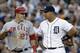 Los Angeles Angels' Mike Trout (27) talks to Detroit Tigers third baseman Miguel Cabrera after advancing to third base on an Albert Pujols fly out in the third inning of a baseball game in Detroit, Tuesday, June 25, 2013. (AP Photo/Paul Sancya)