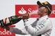 Britain's Lewis Hamilton of Mercedes drinks champagne as he celebrates after winning the British Formula One Grand Prix at Silverstone circuit, Silverstone, England, Sunday, July 6, 2014. Finland's Valtteri Bottas of Williams finished second, and Australia's Daniel Ricciardo of Red Bull finished third. (AP Photo/Lefteris Pitarakis)
