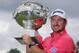 Graeme McDowell of Northern Ireland poses with his trophy after winning the French Open Golf tournament at Paris National course in Guyancourt, west of Paris, France, Sunday, July 6, 2014. (AP Photo/Francois Mori)