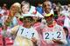 RECIFE, BRAZIL - JUNE 26: Fans hold up a replica of the World Cup trophy while wearing masks of Angela Merkel and Barack Obama during the 2014 FIFA World Cup Brazil group G match between the United States and Germany at Arena Pernambuco on June 26, 2014 in Recife, Brazil. (Photo by Robert Cianflone/Getty Images)