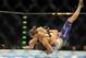 Jul 5, 2014; Las Vegas, NV, USA; Ronda Rousey (red gloves) takes down Alexis Davis (blue gloves) during the first round of a bantamweight fight at Mandalay Bay Events Center. Mandatory Credit: Stephen R. Sylvanie-USA TODAY Sports