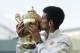 Novak Djokovic of Serbia kisses the trophy after defeating Roger Federer of Switzerland in the men's singles final match at the All England Lawn Tennis Championships in Wimbledon, London, Sunday July 6, 2014. (AP Photo/Sang Tan, Pool)