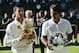 Serbia's Novak Djokovic, left, holds his trophy after defeating Switzerland's Roger Federer, right, in the men's singles final match at the All England Lawn Tennis Championships in Wimbledon, London, Sunday, July 6, 2014. (AP Photo/Ben Curtis)