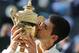 Novak Djokovic of Serbia kisses the trophy after defeating Roger Federer of Switzerland in the men's singles final at the All England Lawn Tennis Championships in Wimbledon, London, Sunday July 6, 2014. (AP Photo/Ben Curtis)
