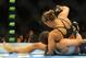 Jul 5, 2014; Las Vegas, NV, USA; Ronda Rousey (red gloves) throws punches at a prone Alexis Davis (blue gloves) during a women's bantamweight title bout at Mandalay Bay Events Center. Mandatory Credit: Stephen R. Sylvanie-USA TODAY Sports