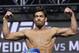 Lyoto Machida poses on the scale during a weigh-in for the UFC 175 mixed martial arts event at the Mandalay Bay, Friday, July 4, 2014, in Las Vegas. Machida is scheduled to fight Chris Weidman in a middleweight title bout on Saturday in Las Vegas. (AP Photo/John Locher)