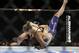 Ronda Rousey, left, takes down Alexis Davis during their women's mixed martial arts bantamweight title bout at UFC 175 on Saturday, July 5, 2014, in Las Vegas. (AP Photo/John Locher)