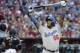 Los Angeles Dodgers' Yasiel Puig reacts after striking out to end the top of the fifth inning of a baseball game as Arizona Diamondbacks catcher Tuffy Gosewisch heads to the dugout on Saturday, May 17, 2014, in Phoenix. (AP Photo/Matt York)
