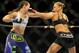 Jul 5, 2014; Las Vegas, NV, USA; Ronda Rousey (red gloves) trades punches with Alexis Davis (blue gloves) during a women's bantamweight title bout at Mandalay Bay Events Center. Mandatory Credit: Stephen R. Sylvanie-USA TODAY Sports