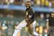 Pittsburgh Pirates' Josh Harrison (5) runs away from his teammates after he drove in Clint Barmes with the game winning run in the 11th inning of the baseball game against the New York Metson Friday, June 27, 2014, in Pittsburgh. the Pirates won 3-2 in 11 innings. (AP Photo/Keith Srakocic)