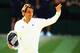 LONDON, ENGLAND - JULY 06: Roger Federer of Switzerland waves to the fans as he holds the runner up trophy after the Gentlemen's Singles Final match against Novak Djokovic of Serbia on day thirteen of the Wimbledon Lawn Tennis Championships at the All England Lawn Tennis and Croquet Club on July 6, 2014 in London, England. (Photo by Al Bello/Getty Images)