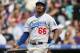 Los Angeles Dodgers' Yasiel Puig reacts after missing a pitch in the fifth inning of a baseball game against the Colorado Rockies in Denver, Thursday, July 3, 2014. (AP Photo/David Zalubowski)