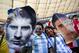 Fans of Argentina's national soccer team hold face cutouts of Lionel Messi, left, and Angel Di Maria, during the World Cup quarterfinal match between Argentina and Belgium at the Estadio Nacional in Brasilia, Brazil, Saturday, July 5, 2014. (AP Photo/Rodrigo Abd)