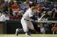 Houston Astros' Jose Altuve follows through on a hit against the Texas Rangers in a baseball game, Monday, July 7, 2014, in Arlington, Texas. (AP Photo/Tony Gutierrez)