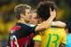 BELO HORIZONTE, BRAZIL - JULY 08: Thomas Mueller (L) and Bastian Schweinsteiger of Germany console Dante of Brazil after Germany's 7-1 win during the 2014 FIFA World Cup Brazil Semi Final match between Brazil and Germany at Estadio Mineirao on July 8, 2014 in Belo Horizonte, Brazil. (Photo by Martin Rose/Getty Images)