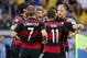 Brazil's Oscar, right, passes by celebrating German players after Germany's Thomas Mueller scored the opening goal during the World Cup semifinal soccer match between Brazil and Germany at the Mineirao Stadium in Belo Horizonte, Brazil, Tuesday, July 8, 2014. (AP Photo/Frank Augstein)