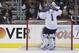 Bailey, mascot for the Los Angeles Kings, hold signs as St. Louis Blues goalie Brian Elliott drinks water during the third period in Game 3 of a first-round NHL hockey Stanley Cup playoff series in Los Angeles, Saturday, May 4, 2013. The Kings won 1-0. (AP Photo/Jae C. Hong)