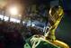 Brazilian residents watch the opening match of FIFA World Cup between Brazil and Croatia behind a replica of the trophy in Porto Seguro, Brazil, Thursday, June 12, 2014. (AP Photo/Matthias Schrader)