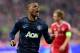 Manchester United's Patrice Evra, left, celebrates his side's opening goal during the Champions League quarterfinal second leg soccer match between Bayern Munich and Manchester United in the Allianz Arena in Munich, Germany, Wednesday, April 9, 2014. At right is Bayern's Philipp Lahm. (AP Photo/Kerstin Joensson)