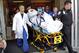 Bryan Stow, a Santa Clara, Calif., area paramedic, who suffered brain damage in an attack on opening day of the Dodgers opener in March with his neurosurgeon Dr. Gabriel Zada, left, the LAC-USC medical team and the air and ground transport team move him to a waiting ambulance Monday May 16, 2011, at the County USC Medical Center Emergency Room Ambulance entrance Monday morning for transport to Burbank airport where he will be flown to San Francisco. (AP Photo/Al Seib,Pool)**MANDATORY CREDIT**