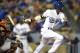 Los Angeles Dodgers’ Dee Gordon follows through on a hit for a single during the sixth inning of a baseball game against the San Francisco Giants in Los Angeles, Thursday, May 8, 2014. (AP Photo/Kelvin Kuo)
