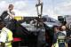 Mechanics cover the car of Germany's Nico Rosberg of Mercedes following the British Formula One Grand Prix at Silverstone circuit, Silverstone, England, Sunday, July 6, 2014. Rosberg failed to complete the race due to mechanical failure. Britain's Lewis Hamilton of Mercedes won the race, Finland's Valtteri Bottas of Williams finished second and Australia's Daniel Ricciardo of Red Bull finished third.(AP Photo/Lefteris Pitarakis)