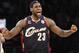 FILE - In this Dec. 25, 2009 file photo, Cleveland Cavaliers forward LeBron James reacts during the second half against the Los Angeles Lakers in an NBA basketball game in Los Angeles. The three-team trade that gave the Cavaliers salary cap space to possibly land LeBron James is official. The Cavs and Boston Celtics confirmed the deal on Thursday, July 10, 2014, when the NBA moratorium on signings ended. (AP Photo/Lori Shepler, File)
