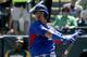 Chicago Cubs' Javier Baez strikes out against the Oakland Athletics during the first inning of a spring exhibition baseball game in Phoenix, Monday, March 17, 2014. (AP Photo/Chris Carlson)