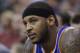 New York Knicks' Carmelo Anthony (7) looks on as he sits on the bench in the second quarter during an NBA basketball game against the Utah Jazz Monday, March 31, 2014, in Salt Lake City. (AP Photo/Rick Bowmer)
