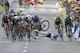 Andrew Talansky of the U.S. crashes as the pack with stage winner Italy's Matteo Trentin, foreground left, sprints towards the finish line during the seventh stage of the Tour de France cycling race over 234.5 kilometers (145.7 miles) with start in Epernay and finish in Nancy, France, Friday, July 11, 2014. (AP Photo/Peter Dejong)