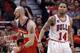 Washington Wizards center Marcin Gortat, left, reacts after scoring a basket as Chicago Bulls guard D.J. Augustin reacts during the second half in Game 1 of an opening-round NBA basketball playoff series in Chicago, Sunday, April 20, 2014. The Wizards won 102-93. (AP Photo/Nam Y. Huh)
