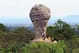CAPTION CORRECTION REMOVES THE PHOTOGRAPHER'S BYLINE Visitors climb a World Cup Trophy shaped rock at Pa Hin Ngam national park in Chaiyaphum province, northeastern Thailand, Saturday, July 12, 2014. The World Cup soccer final between Germany and Argentina is to played on Sunday, July 13, 2014 in Brazil. (AP Photo)