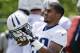 Tennessee Titans running back Bishop Sankey (20) puts on his helmet during NFL football practice Thursday, June 12, 2014, in Nashville, Tenn. Rookie Sankey finally joined the Titans' offseason program just in time for their final organized team activity. The second-round pick from Washington couldn't stay with the team until he wrapped up his exams. (AP Photo/Mark Humphrey)