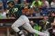MIAMI, FL - JUNE 27: Yoenis Cespedes #52 of the Oakland Athletics hits during a game against the Miami Marlins at Marlins Park on June 27, 2014 in Miami, Florida. (Photo by Mike Ehrmann/Getty Images)