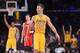 Los Angeles Lakers' Steve Nash, center, smiles after picking up an assist to take sole possession of third place for NBA all-time assists, during the first half of an NBA basketball game against the Houston Rockets, Tuesday, April 8, 2014, in Los Angeles. (AP Photo/Mark J. Terrill)