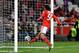 Benfica's Lazar Markovic, from Serbia, right, scores the opening goal after chipping the ball over the Guimaraes' goalkeeper during their Portuguese league soccer match Monday, Feb. 24 2014, at Benfica's Luz stadium in Lisbon. (AP Photo/Armando Franca)