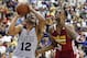 Jabari Parker (12) of the Milwaukee Bucks drives by Andrew Wiggins of the Cleveland Cavaliers in an NBA summer league basketball Friday, July 11, 2014, in Las Vegas. (AP Photo/John Locher)