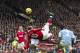 FILE - In this Feb. 12, 2011, file photo, Manchester United's Wayne Rooney, center, scores the game-winning goal with an overhead kick against Manchester City during their English Premier League soccer match at Old Trafford Stadium, Manchester, England. Rooney's fantastic finish is featured on the 10-goal shortlist published by FIFA on Friday, Nov. 18, 2011, competing to be chosen as the best score in 2011. (AP Photo/Jon Super, File)