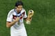 Germany's Sami Khedira points at the trophy after winning the World Cup final soccer match between Germany and Argentina at the Maracana Stadium in Rio de Janeiro, Brazil, Sunday, July 13, 2014. Mario Goetze volleyed in the winning goal in extra time to give Germany its fourth World Cup title with a 1-0 victory over Argentina on Sunday. (AP Photo/Fabrizio Bensch, Pool)