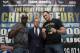 Boxers Dereck Chisora, left, and Tyson Fury stand either side of Francis Warren, son of promoter Frank Warren at a press conference to publicise their forthcoming world title eliminator fight, Manchester, England, Thursday March 20, 2014. The fight will take place on 26 July in Manchester with the winner possibly going on to challenge IBF, WBA and WBO heavyweight champion Wladimir Klitschko. (AP Photo/Jon Super)