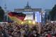 Thousands of German soccer fans wait for the live broadcast of the final match between Germany and Argentina at the soccer World Cup in Rio de Janeiro, Brazil, at a public viewing area called 'Fan Mile' in front of the Brandenburg Gate in Berlin, Sunday, July 13, 2014. (AP Photo/Markus Schreiber)