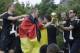 Bastian Schweinsteiger gives the trophy to team manager Oliver Bierhoff during a fan party after the arrival of the German national soccer team in Berlin Tuesday, July 15, 2014. Germany beat Argentina 1-0 on Sunday to win its fourth World Cup title. (AP Photo/Michael Sohn)