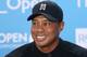 Tiger Woods of the US smiles during a press conference ahead of the British Open Golf championship at the Royal Liverpool golf club, Hoylake, England, Tuesday July 15, 2014. The British Open starts on Thursday July 17. (AP Photo/Peter Morrison)