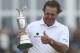 Phil Mickelson of the United States gestures as he holds up the Claret Jug trophy after winning the British Open Golf Championship at Muirfield, Scotland, Sunday July 21, 2013. (AP Photo/Scott Heppell)