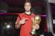 Photo provided by Germany soccer federation DFB shows Germany's Mario Goetze with the trophy during the party of the German soccer federation after Germany beat Argentina 1-0 after extra-time in the soccer World Cup final to win its fourth title in Rio de Janeiro, Brazil, Sunday, July 13, 2014. (AP Photo/DFB, Markus Gilliar, pool)