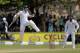 South African batsman Dean Elgar celebrates scoring a century as Sri Lanka wicketkeeper Dinesh Chandimal watches during the first day of the first test cricket match between Sri Lanka and South Africa in Galle, Sri Lanka, Wednesday, July 16, 2014. (AP Photo/Eranga Jayawardena)