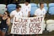 Three supporters wear England's jerseys and hold a banner referring to Britain's coach Roy Hodgson prior to the World Cup quarterfinal soccer match between Germany and France at the Maracana Stadium in Rio de Janeiro, Brazil, Friday, July 4, 2014. (AP Photo/Matt Dunham, pool)