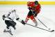 Chicago Blackhawks right wing Marian Hossa (81) and Los Angeles Kings defenseman Jake Muzzin (6) battle during the third period in Game 5 of the Western Conference finals in the NHL hockey Stanley Cup playoffs on Wednesday, May 28, 2014, in Chicago. The Blackhawks won 5-4 in the second overtime. (AP Photo/Andrew A. Nelles)